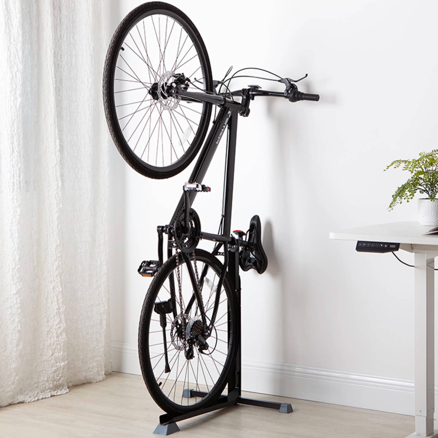 A bicycle held upright on a vertical bike stand